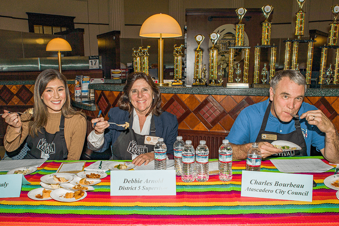 Image of 2020 Tamale Festival Tamale Judges Megan Healy - KSBY, Supervisor Debbie Arnold and Council Member Bourbeau poised to sample a bite of tamale.